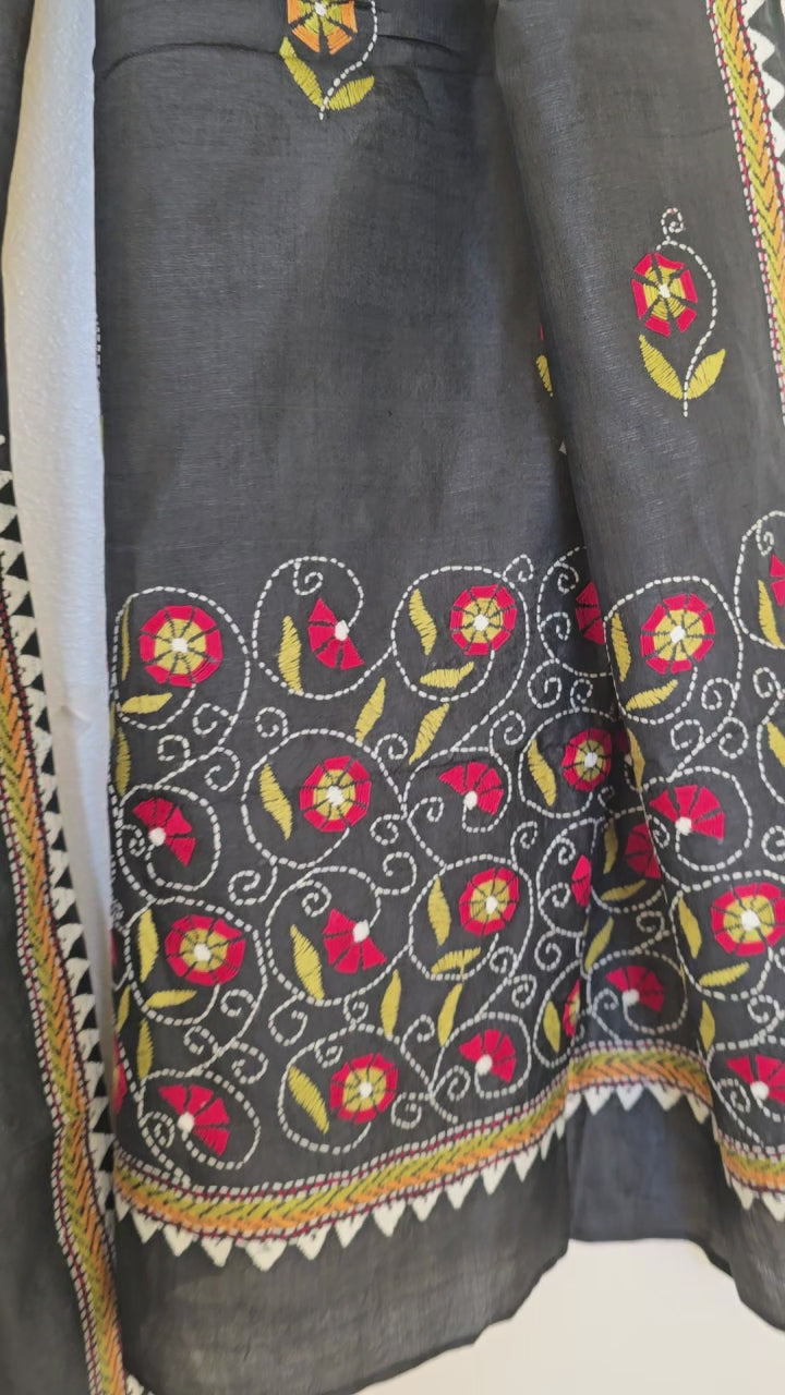 Close up of Black Kantha embroidered silk scarf on a white background